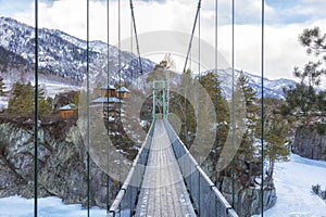 Suspension bridge to John Baptist skete Barnaul Znamensky women monastery in Patmos village of Chemal in winter.