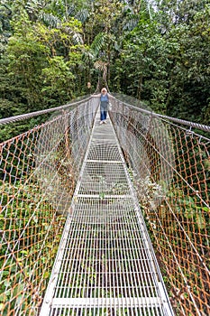 Suspension bridge in tropical rain forest of Costa