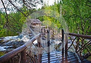 Suspension cable bridge crossing the river