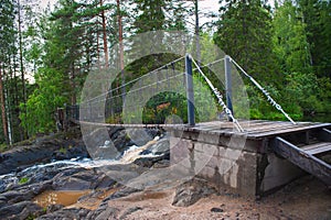 Suspension cable bridge crossing the river