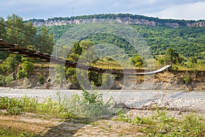 Suspension cable bridge, Crossing the river. Adygea republic, Krasnodar region, Russia