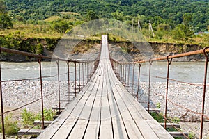 Suspension cable bridge, Crossing the river. Adygea republic, Krasnodar region, Russia