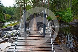 Suspension cable bridge crossing the river