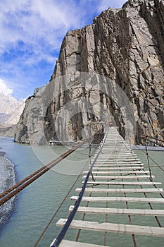 Suspension Hussaini bridge in Passu, Upper Hunza. Karakoram mountains and Hunza river