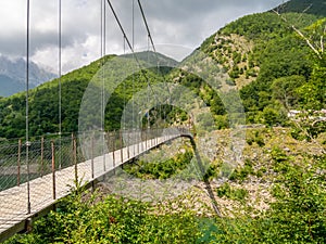 Suspension pedestrian bridge over Vagli Lake near Vagli di Sotto village in Lucca province, Italy, with no identifiable photo