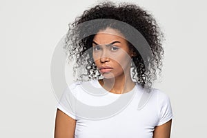 Suspicious african woman with distrustful face looking at camera photo