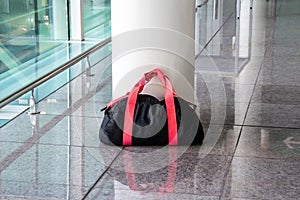 Suspicious black and red bag left unattended in an empty hall. Concept of terrorism and public safety. Dangerous ownerless