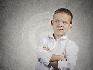 Suspicious, cautious child boy looking with disbelief photo