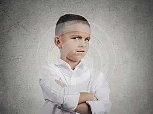 Suspicious, cautious child boy looking with disbelief photo