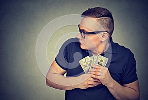 Suspicious greedy man grabbing money