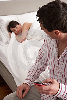 Suspicious Husband Checking Wife's Mobile Phone