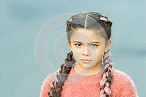 Suspicious look. Girl with braided hair style pink kanekalon. Hairdresser salon. Braided cutie. Little girl with cute