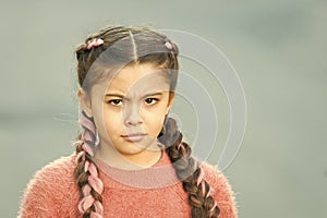 Suspicious look. Girl with braided hair style pink kanekalon. Hairdresser salon. Braided cutie. Little girl with cute