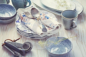 Sustainability concept - stoneware and kitchenware on wooden table photo