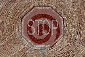 Sustainability concept: traffic stop sign in front of fallen trees