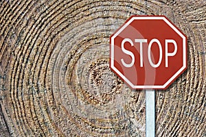 Sustainability concept: traffic stop sign in front of fallen trees