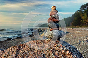 Sustainable cairn at sea in pastel colors