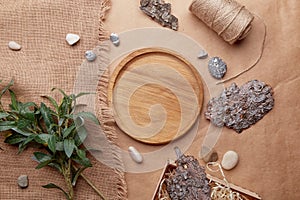 Sustainable, eco-friendly lifestyle. Natural wooden mockup - template tray among tree bark, cotton thread, green leaves