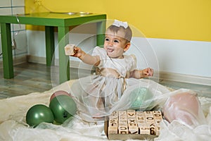 Sustainable eco-friendly safe wooden toys for baby and kids. Baby girl play with wooden blocks made with organic