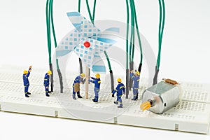 Sustainable energy, alternative clean eco power concept, miniature people worker help building windmill electricity generator to