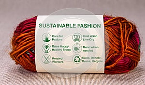 Sustainable fashion label on ball of wool with care icons and text, ethical consumerism