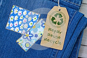 Sustainable fashion label on repaired jeans photo
