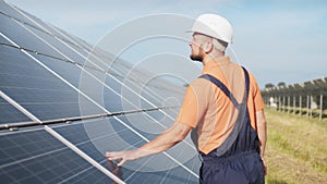 Sustainable green energy jobs, solar panel technician working with solar panels. Assistance technical worker in uniform