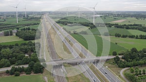 Sustainable transit: wind turbines overlook bustling highway