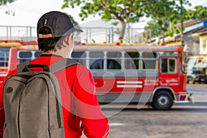 Sustainable transport, Sustainable tourism reduces global warming and saves money, traveling by bus, Asian male tourist holding a