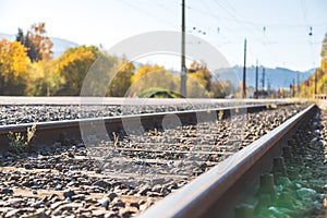 Sustainable traveling by train: Rail track and colorful, idyllic landscape in fall