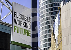 Sustainable Working Revolution sign in front of a modern office building
