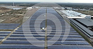 SustainableClimateVisuals aerial drone view on solar panels on industrial park. Sustainable energy generation. Birds eye