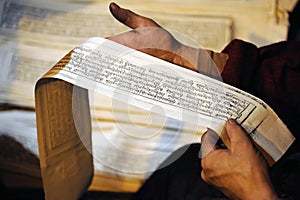 Sutras on the tibetan worker hands. photo