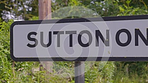 Sutton on Trent signage standing along a busy road