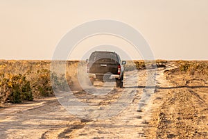 SUV 4x4, drives off-road in deep sand in huge desert sand dunes in Liwa desert. Extreme 4x4 off-road concept.
