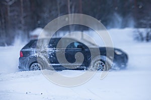 SUV car drifting in snow, during competition, sport car racing drift on snowy race track in winter