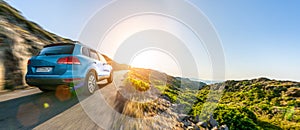 SUV car in spain mountain landscape road at sunset