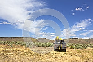 SUV Car With Yellow Kayaks In Desert