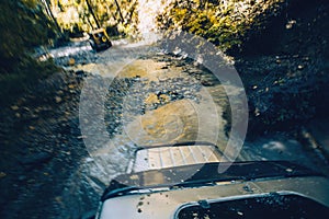 SUV cross the mountain river in forest. Gelendzhik, Russia