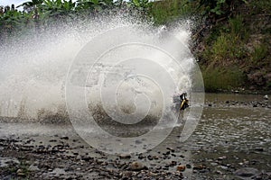 SUV crossing water at high speed