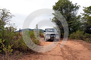 SUV driving on dirt road