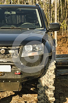 SUV with lifted suspension.In forest in Siberia.