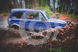 Suv offroad 4wd car rides through muddy puddle, off-road track road, with a big splash, during a jeeping competition