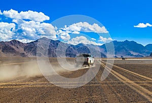 SUV raises clouds of dust on a mountain