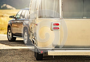 SUV with Retro Classic Travel Trailer Road Trip