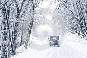 SUV on a snowy road in the forest