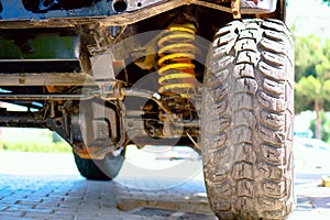 SUV transmission. Oversized off-road wheel tread. Yellow shock absorber spring