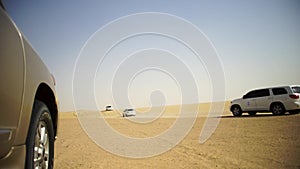 SUV Trip for tourists in the desert. Stock. Group of people driving off road car in the Vietnam desert during a safari