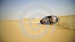 SUV Trip for tourists in the desert. Stock. Group of people driving off road car in the Vietnam desert during a safari