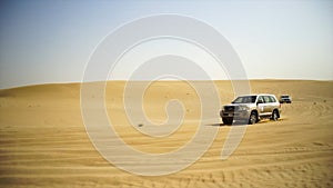 SUV Trip for tourists in the desert. Stock. Group of people driving off road car in the Vietnam desert during a safari